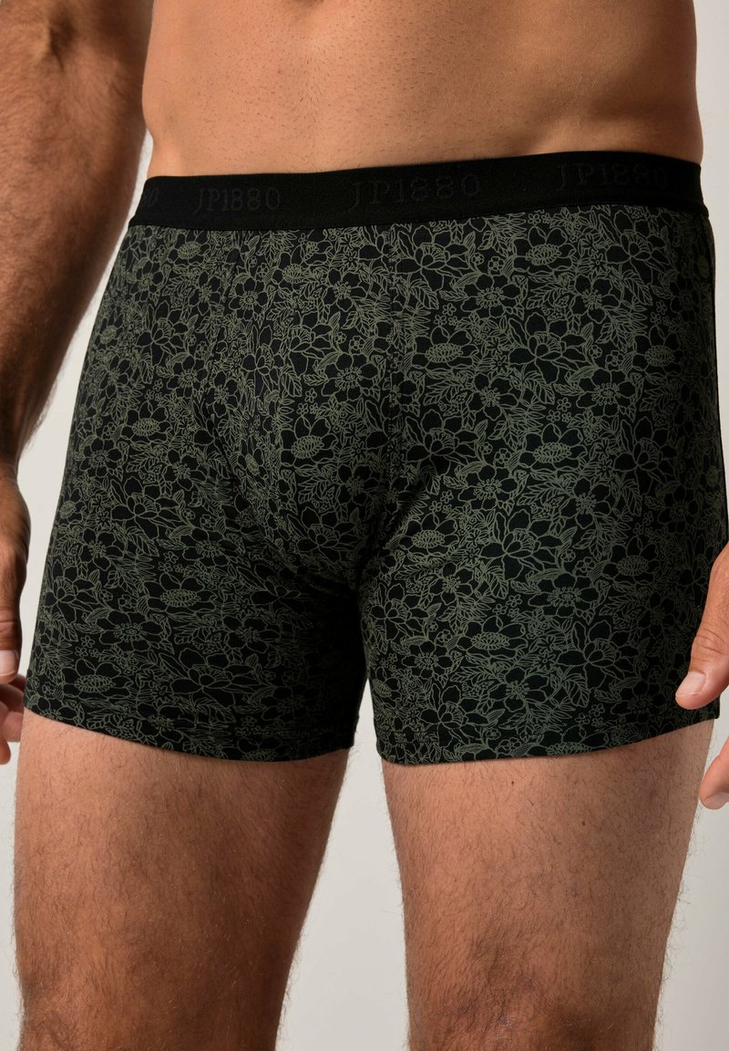 Boxers noirs avec un motif floral en vert foncé. Dotés d'une ceinture douce avec le nom de la marque "JP1880" affiché en évidence.