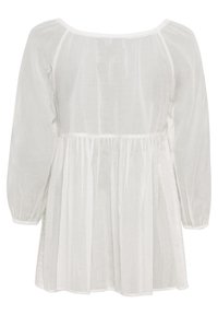 White blouse with a loose fit, long puffed sleeves, elastic cuffs, and a gathered waist. Made of lightweight, semi-sheer fabric with textured accents.