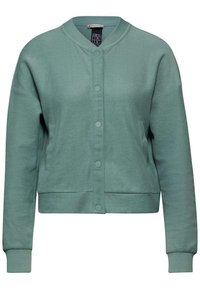 Veste bomber en coton vert avec un col rond, fermeture à boutons-pression sur le devant et poignets côtelés. Texture douce et coupe décontractée.