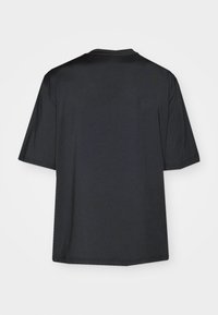 Black athletic shirt with short sleeves, featuring a round neckline and perforated texture on the back for ventilation.