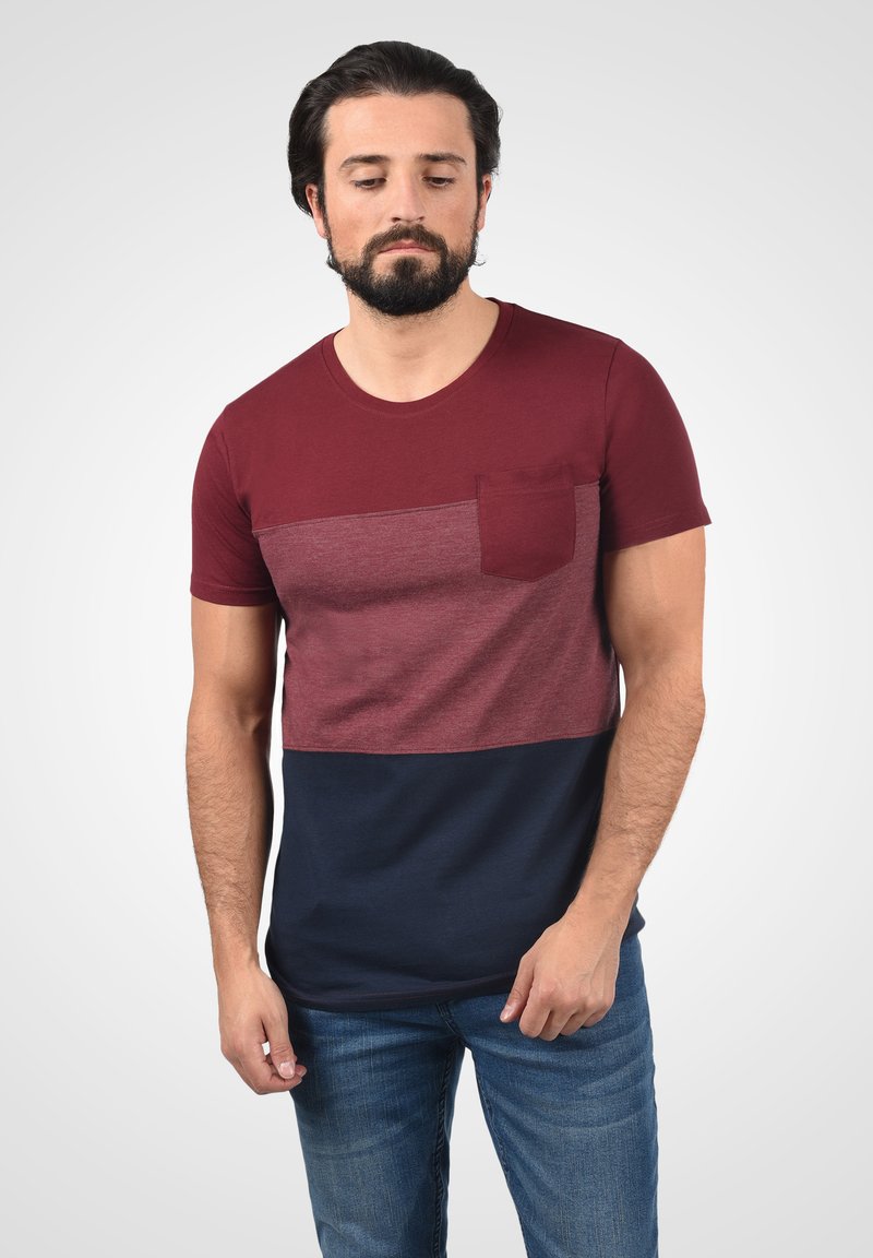 Maroon and navy color-blocked t-shirt with short sleeves, a round neckline, and a chest pocket; made of soft fabric with a smooth texture.