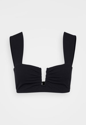 Zwarte bandeau beha met een textuurstof, ruches aan de voorkant, brede bandjes en een kleine centrale uitsnede met hardwaredetail.