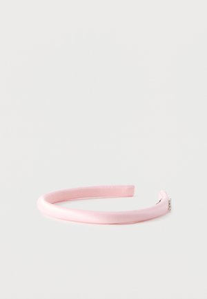 Light pink satin-covered headband with small rhinestone detailing on one end, displayed on a plain white background.