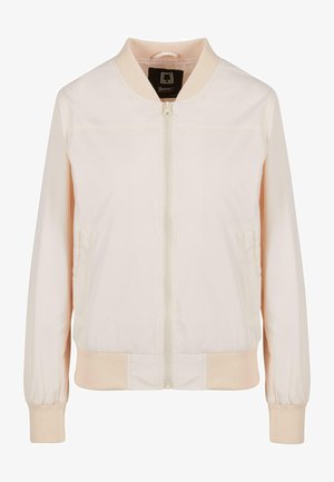 Világos rózsaszín bombázó dzseki sima anyagból. Elől zippes, bordázott mandzsettái és gallérja van. Két oldalzseb található rajta.