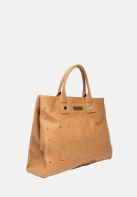Lichtbruine leren tote bag met dubbele handvatten en gelijkmatig verdeelde metalen oogjes versieringen aan de voorkant en zijkanten.
