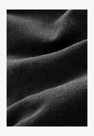 Black woven fabric with a smooth texture, featuring subtle sheen and diagonal weave patterns. The surface is consistent with no visible embellishments.