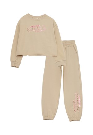 Felpa beige corta con stampa rosa "danza" e pantaloni abbinati con elastici alle estremità e in vita, realizzati in morbido cotone.