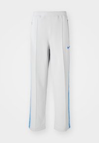 Light grey athletic pants with blue side stripes, featuring a relaxed fit, elastic waistband, and zippered pockets. Nike logo on the front.