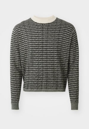 Black and white cropped sweater featuring a repeated logo pattern, ribbed neck and cuffs, with a soft knit texture.