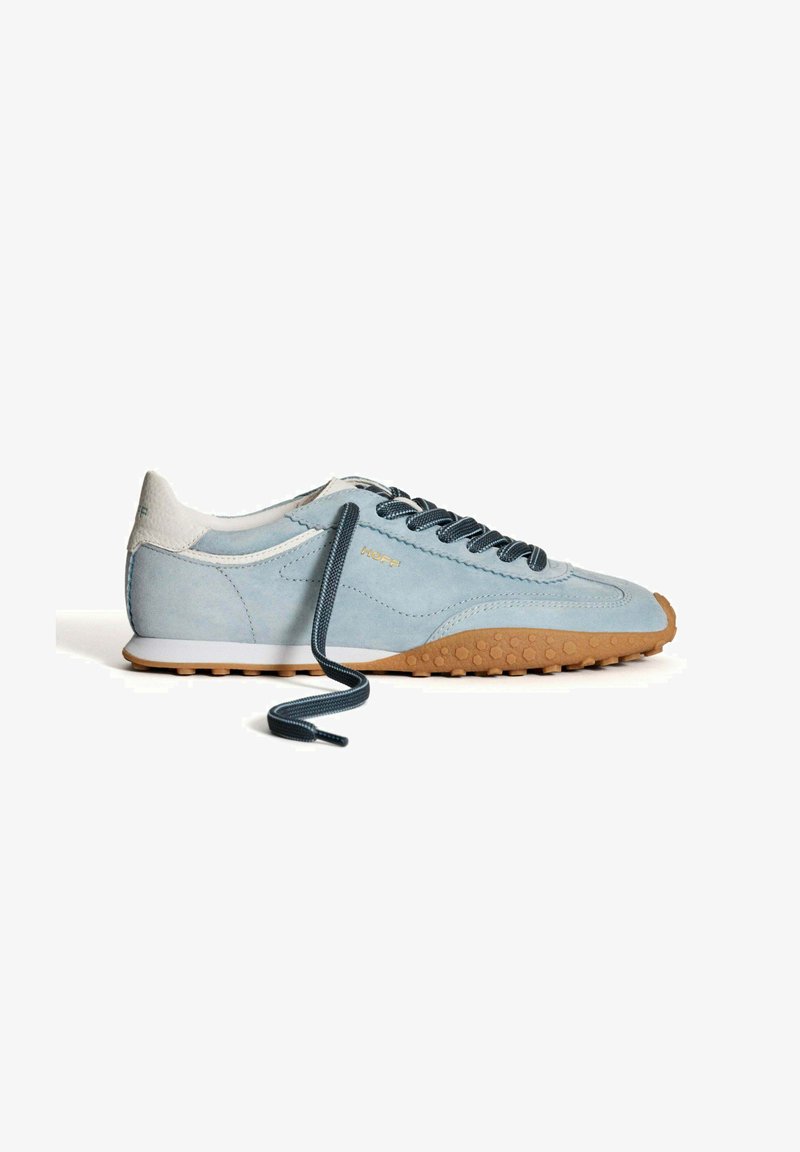 Baskets en daim bleu clair avec un talon blanc et une semelle en caoutchouc marron. Dotées de lacets bleu foncé et d'accents texturés sur la semelle. Détail du logo en or.