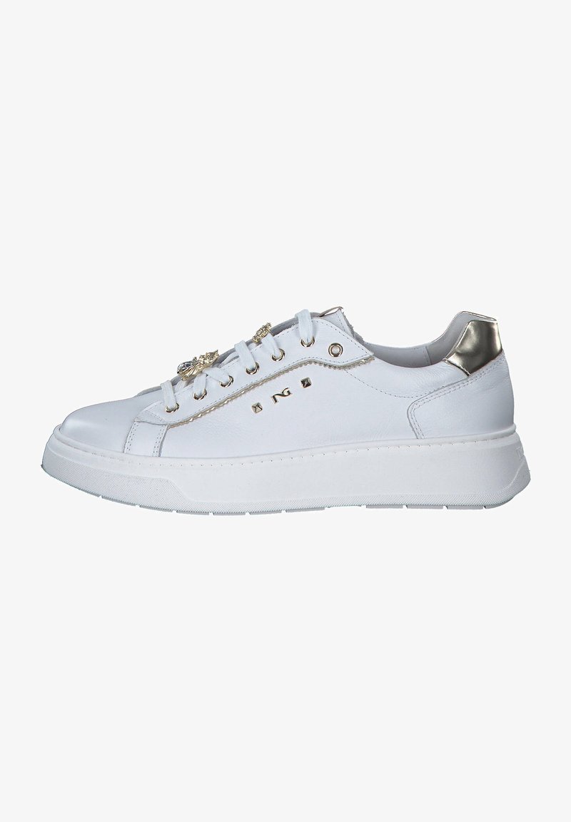 White synthetic sneakers with metallic accents, flat laces, and a thick sole. Features decorative elements on the side and a smooth texture.