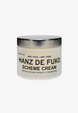 Barattolo di vetro trasparente con un coperchio in metallo argentato, etichettato "Hanz de Fuko Scheme Cream", contiene una crema leggera. Peso netto: 60 g. Senza parabeni.