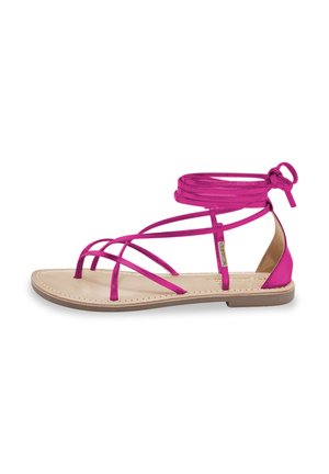 Sandali piatti fucsia con design a più fascette, realizzati in materiale sintetico liscio. Lacci alla caviglia e soletta imbottita per il comfort.