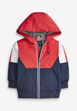 Veste à capuche rouge, marine et blanche avec fermeture éclair à l'avant, poignets et ourlet élastiques. Présente un design coloré en blocs et un petit logo sur la poitrine.