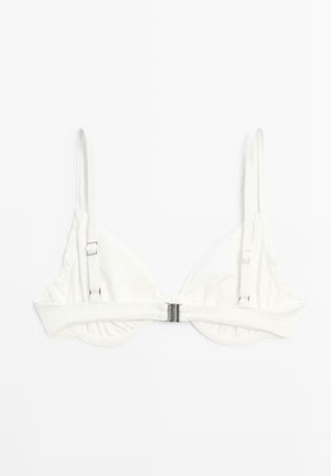 Witte verstelbare beha met dunne bandjes en een metalen sluiting aan de voorkant op een effen witte achtergrond.