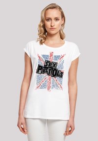 White cotton t-shirt with rolled sleeves featuring a Union Jack design and black "Sex Pistols" text centered on the front.
