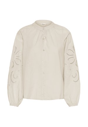 Chemisier beige clair à boutons, fabriqué en tissu léger, ornée de motifs floraux brodés sur les manches et d'un col froncé.