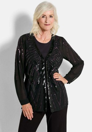 Schwarze transparente Jacke mit langen Ärmeln, verziert mit schwarzen und lila Pailletten in geometrischen Mustern, mit geradem Schnitt und Frontverschluss.