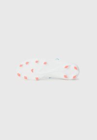 White athletic shoe sole with textured pattern, featuring pink and orange traction studs, and a small blue accent near the heel.