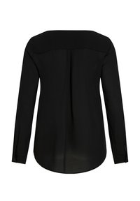 Blouse noire à manches longues avec un ourlet arrondi, texture lisse, poignets à boutons et un pli central dans le dos pour une touche de détail.