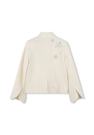 Blazer crème à manches longues, présentant un design au dos avec des étoiles en strass argentés. Coupe ajustée avec une texture lisse.