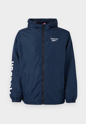 Chaqueta con capucha de Reebok en azul marino con cremallera frontal, forro de forro polar, bolsillos laterales, puños elásticos y logo blanco en el pecho y la manga.