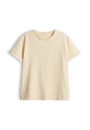 T-shirt in cotone colore crema a maniche corte, collo tondo, polsini arrotolati e piccolo cuore ricamato sul petto sinistro.