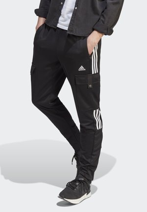 Pantaloni sportivi neri con tre strisce bianche lungo i lati, dotati di tasche cargo e di una vita regolabile con cordino per una vestibilità personalizzata.