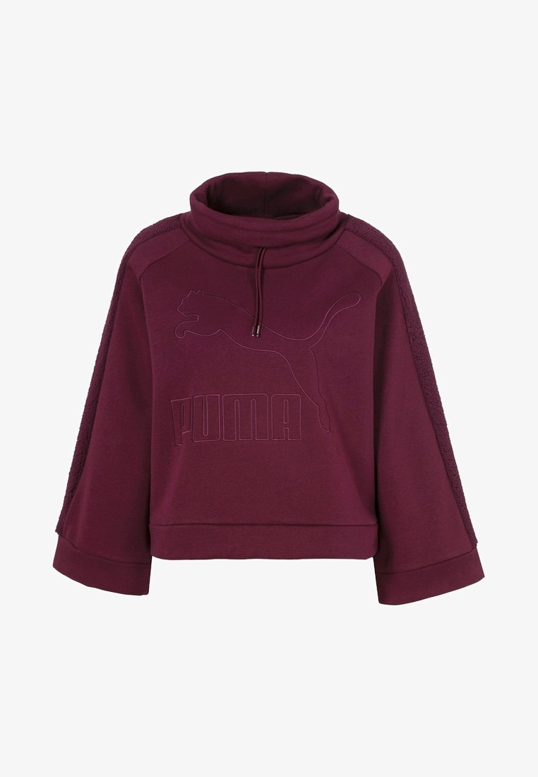 Sudadera burgundy corta con cuello alto, mangas anchas, logo en relieve y paneles laterales texturizados. Fabricada con tejido suave.