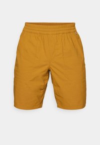 Mustard yellow shorts with an elastic waistband, stitched details, and side pockets. Made from lightweight, textured fabric.