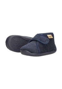 Navy woolen slippers with a Velcro strap, rounded toe, and textured rubber sole for grip. Accented with a tan logo patch.
