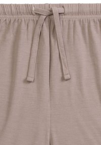 Jasnoróżowe spodnie z troczkiem i elastycznym pasem, o miękkiej fakturze i subtelnym wzorze. Troczek ma oczka do regulacji.