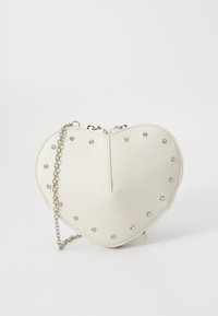 White heart-shaped handbag made of leather, featuring studded embellishments and a silver chain strap. Zippered top for closure.