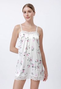White satin nightgown with floral print in pink and green, featuring thin straps and lace trim along the neckline and hem.