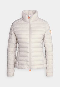 Lightweight puffer jacket in pale beige with horizontal quilting. Features a high neck, front zipper with an orange pull tab, and no visible hardware.