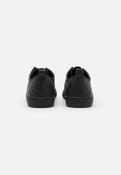 Black leather shoes with a smooth texture, rounded design, low-profile rubber sole, and back pull tab for easy wear.
