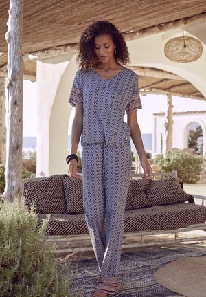 Patterned loungewear set featuring a V-neck short-sleeved top and loose-fitting pants in blue and white with geometric designs and colorful accents.