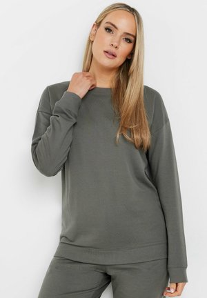 Olive green sweatshirt with long sleeves, crew neckline, and ribbed cuffs and hem. Soft fabric with a relaxed, comfortable fit.