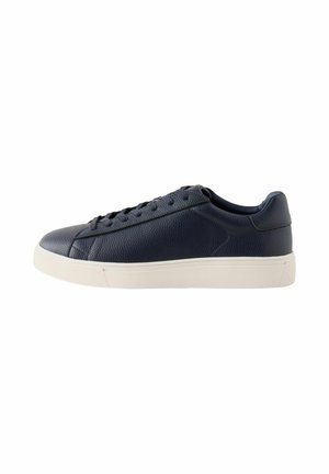 Lage navyblauwe leren sneaker met zwarte veters en witte rubberen zool, zijaanzicht op een effen witte achtergrond.