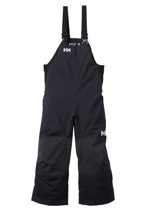 Salopettes noires imperméables avec bretelles réglables et renforts aux genoux, présentant un logo audacieux sur la jambe gauche et une coupe droite.