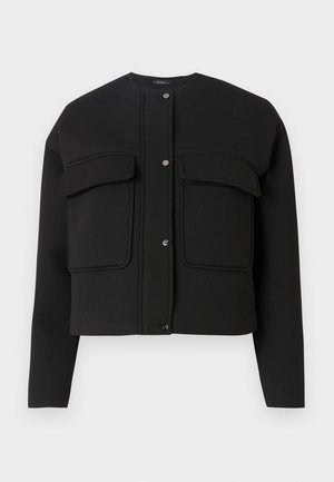 Must must jakk, mis on valmistatud pehmest materjalist, omab kahte esipakki, nupuv closure ja ringikujuline kaelus. Lihtne disain puhaste joontega.