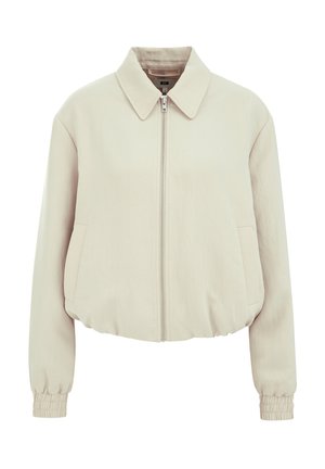 Giacca beige cropped con zip frontale, colletto piatto, due tasche laterali e polsini elasticizzati. Tessuto liscio con una leggera lucentezza.