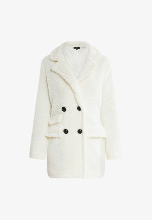 Dubbelknoop jas in zacht wit fauxbont met een gesneden kraag, zwarte knopen en zijzakken. Gezellige textuur en losse silhouet.
