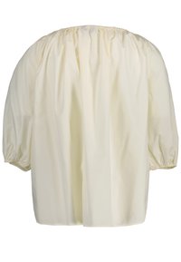 Haut en coton crème à manches bouffantes avec un col froncé et des manches à poignets élastiques. Coupe ample, texture lisse et couleur unie.