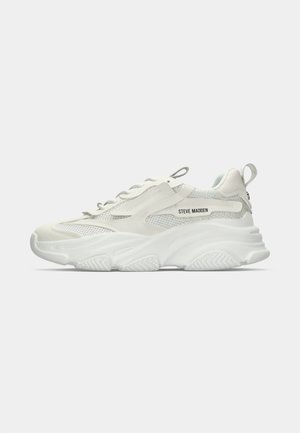 White and gray Steve Madden sneaker with mesh panels, thick sole, lace-up closure, and pull tabs on heel and tongue.