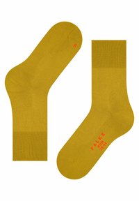 Gelbe Baumwollsocken mit gerippten Bündchen, verstärkten Fersen und rotem "FALKE"-Logo an der Seite. Mit links- und rechtsseitigem Design.