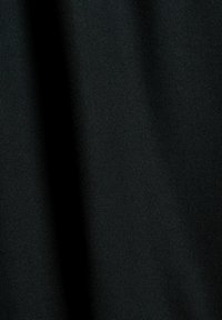 Tela negra con una textura suave, que presenta un patrón sutil. El material parece ligero y cae con facilidad.