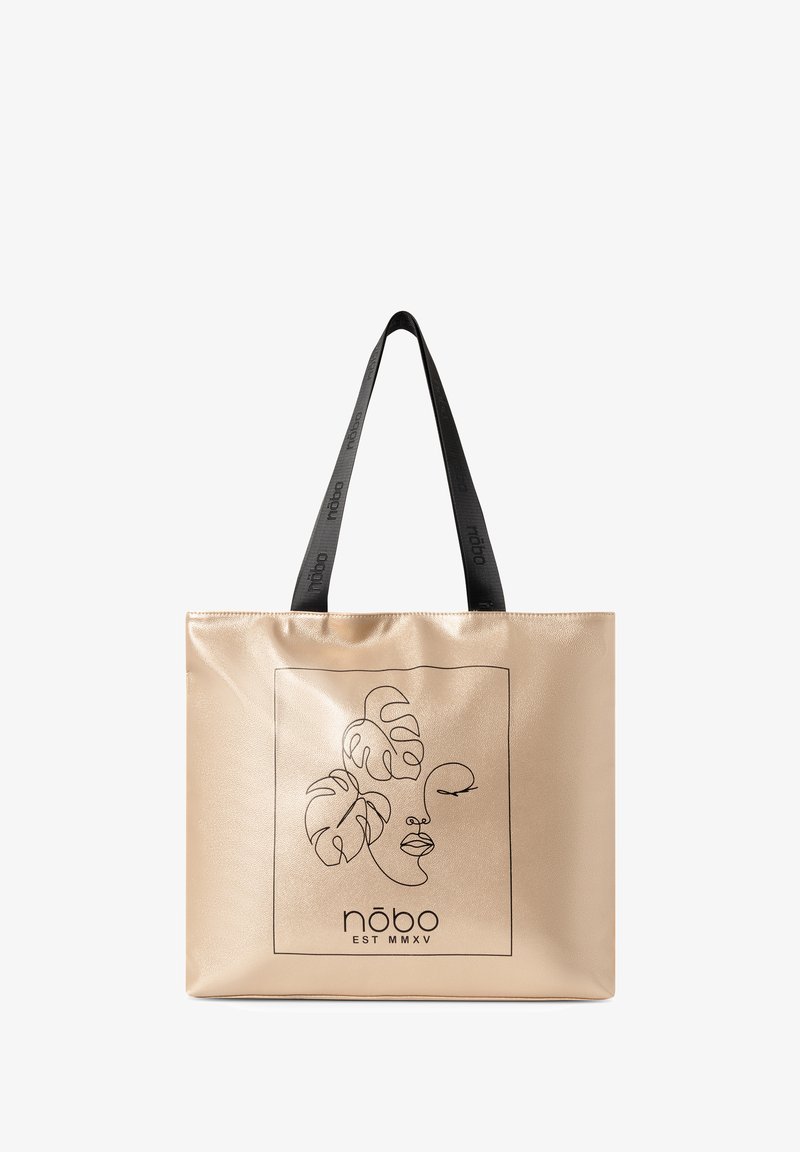 Borsa tote in metallo dorato con manici neri, caratterizzata da un disegno minimale di un volto e foglie tropicali all'interno di un bordo quadrato.