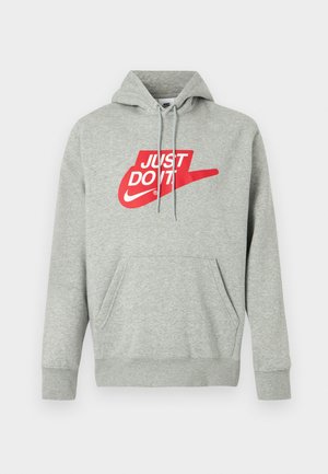 Helehall hall puuvillane kapuutsiga dressipluus esikotiga, millel on suurt punast "JUST DO IT" logo ja Nike Swoosh graafika rinnal.