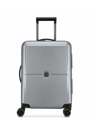 Silver hard-shell suitcase with a glossy finish, a telescopic handle, two black wheels with yellow accents, and a centered circular logo.